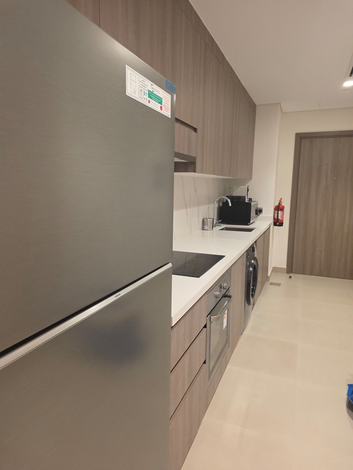 Yas 210 — galley kitchen with washer and oven